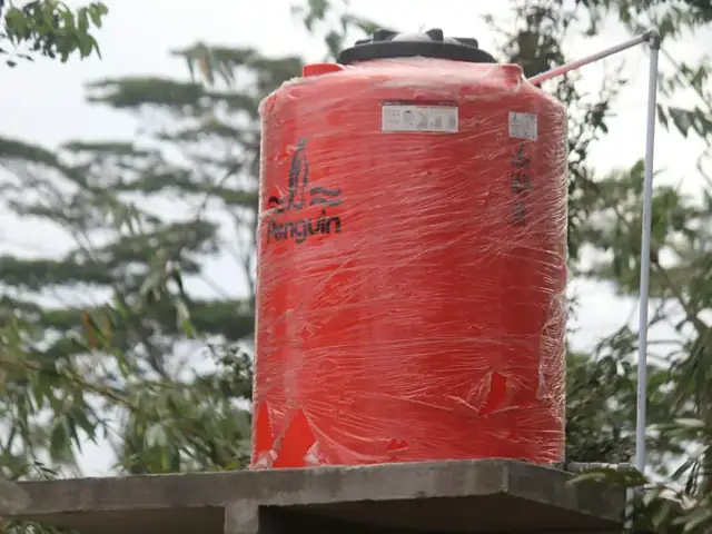 Red water storage tank outdoors