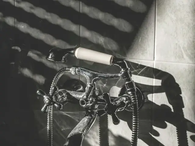 Vintage-style bathtub faucet on a tiled wall