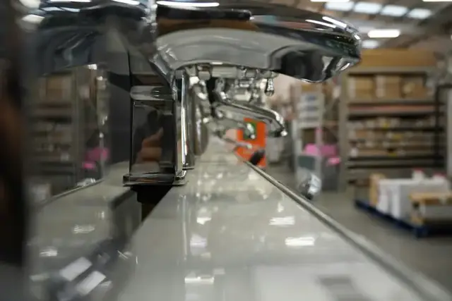 A row of polished chrome faucets on display